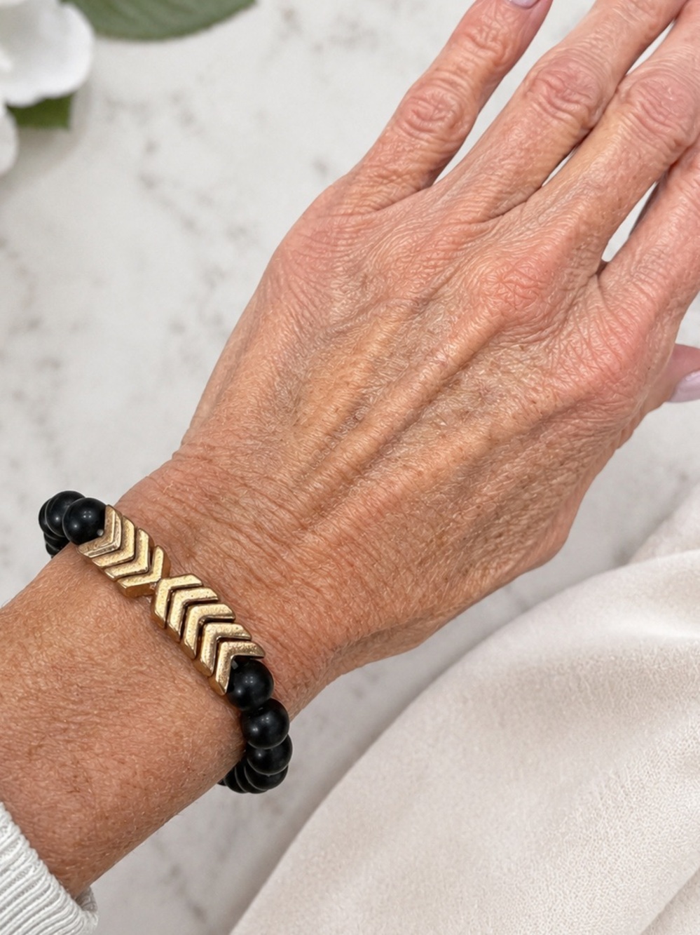 Black Matte Round Beads Stretch Bracelet with gold metal accents